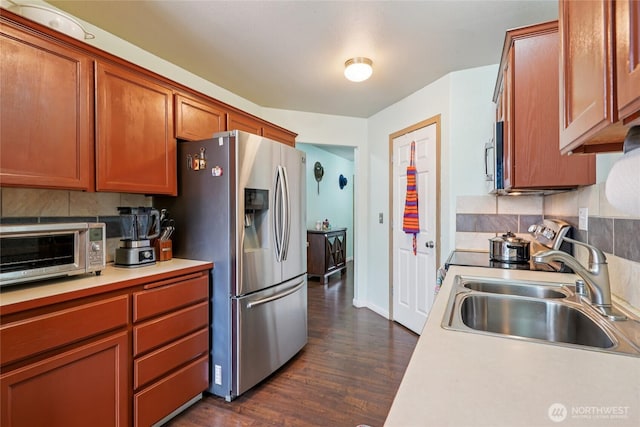 17707 1st Avenue Ct E, Spanaway, WA 98387 - kitchen featuring stainless steel appliances, light countertops, dark wood-style floors, and decorative backsplash