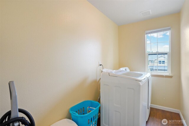 17707 1st Avenue Ct E, Spanaway, WA 98387 - washroom featuring washing machine and clothes dryer and wood finished floors