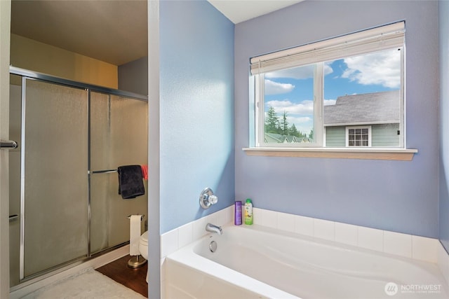 17707 1st Avenue Ct E, Spanaway, WA 98387 - full bathroom with a bath, a shower stall, and wood finished floors