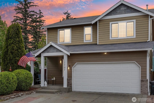 17707 1st Avenue Ct E, Spanaway, WA 98387 - view of front of property featuring a garage, driveway, and a shingled roof