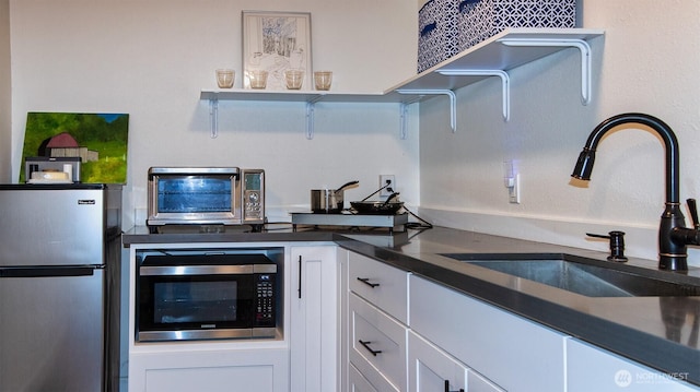 220 Colman Dr, Port Townsend, WA 98368 - kitchen featuring stainless steel appliances, white cabinets, and dark countertops