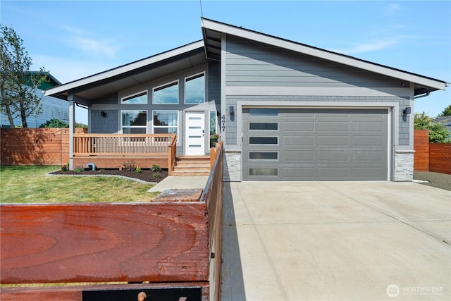 477 Ocean Shores Blvd SW, Ocean Shores, WA 98569 - view of front of home featuring a garage, stone siding, driveway, and covered porch