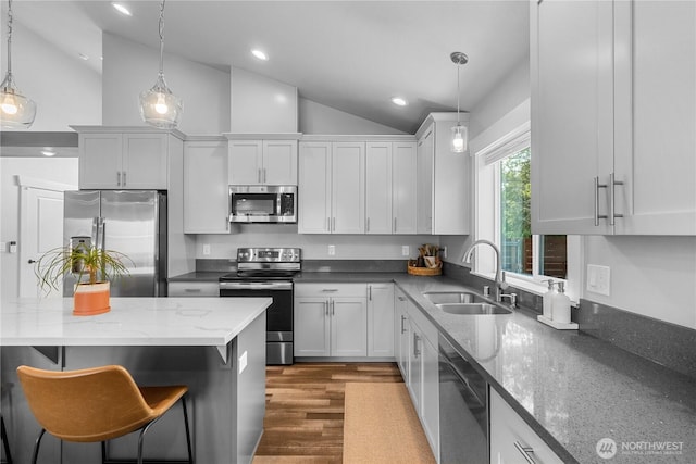 477 Ocean Shores Blvd SW, Ocean Shores, WA 98569 - kitchen with stainless steel appliances, lofted ceiling, recessed lighting, decorative light fixtures, and dark stone countertops