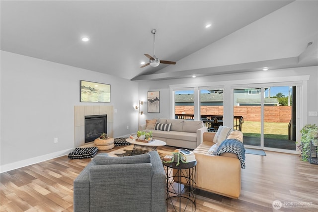 477 Ocean Shores Blvd SW, Ocean Shores, WA 98569 - living room featuring ceiling fan, a tiled fireplace, light wood-type flooring, plenty of natural light, and recessed lighting