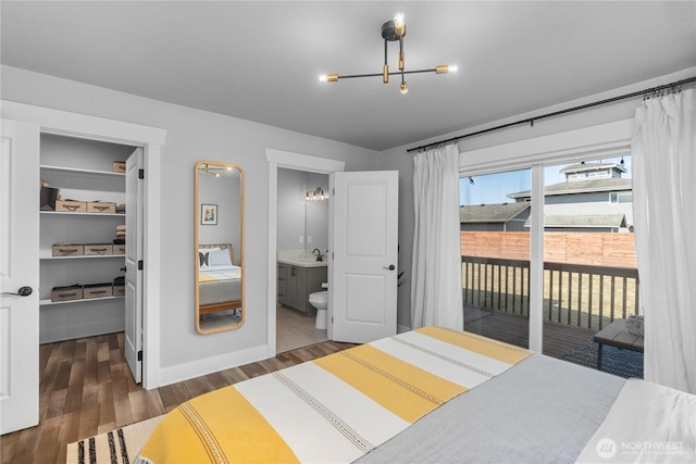 477 Ocean Shores Blvd SW, Ocean Shores, WA 98569 - bedroom with access to outside, wood finished floors, a chandelier, a walk in closet, and ensuite bath