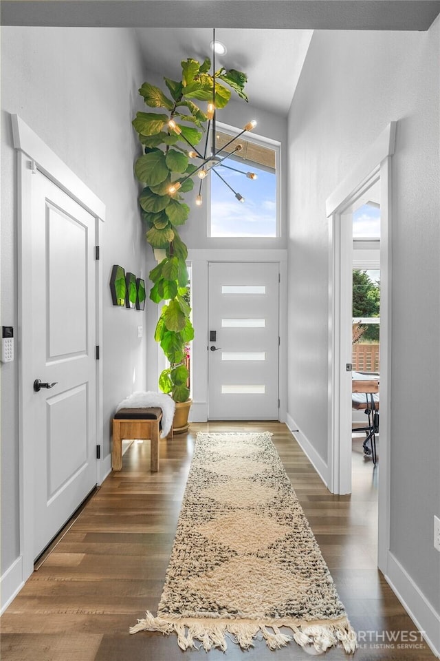 477 Ocean Shores Blvd SW, Ocean Shores, WA 98569 - entryway featuring a chandelier, dark wood finished floors, and a towering ceiling