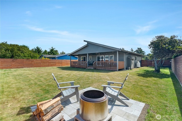 477 Ocean Shores Blvd SW, Ocean Shores, WA 98569 - rear view of house with an outdoor fire pit, a fenced backyard, and a patio