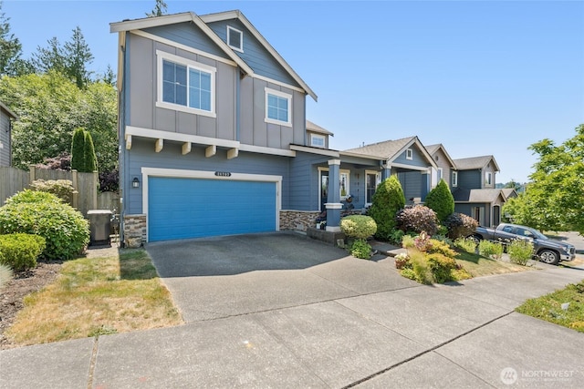 26707 NE 144th Ct, Duvall, WA 98019 - craftsman-style house with board and batten siding, stone siding, an attached garage, and asphalt driveway
