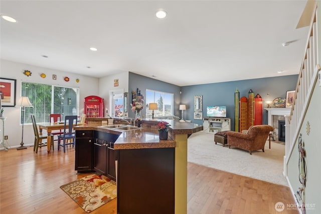 26707 NE 144th Ct, Duvall, WA 98019 - kitchen with a tiled fireplace, open floor plan, healthy amount of natural light, light wood finished floors, and recessed lighting