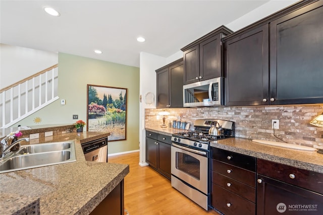 26707 NE 144th Ct, Duvall, WA 98019 - kitchen with appliances with stainless steel finishes, light wood finished floors, backsplash, recessed lighting, and dark brown cabinets