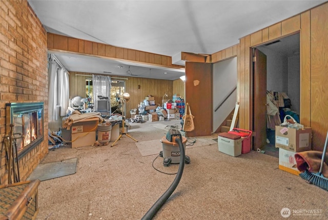 1412 N 40th St, Renton, WA 98056 - carpeted living area with a fireplace, wood walls, and stairs