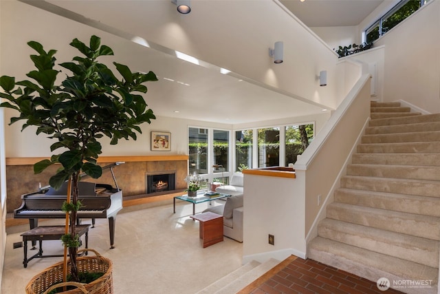 4662 95th Ave NE, Yarrow Point, WA 98004 - living area with plenty of natural light, stairs, and a warm lit fireplace