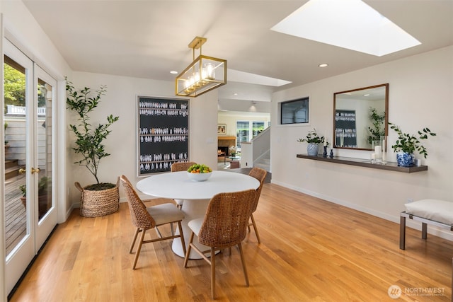 4662 95th Ave NE, Yarrow Point, WA 98004 - dining area featuring stairway, light wood-style floors, recessed lighting, a chandelier, and a skylight