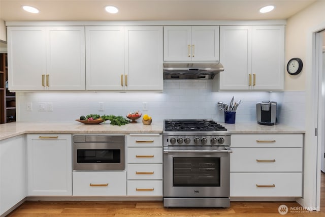 4662 95th Ave NE, Yarrow Point, WA 98004 - kitchen featuring stainless steel stove, under cabinet range hood, white cabinetry, tasteful backsplash, and recessed lighting