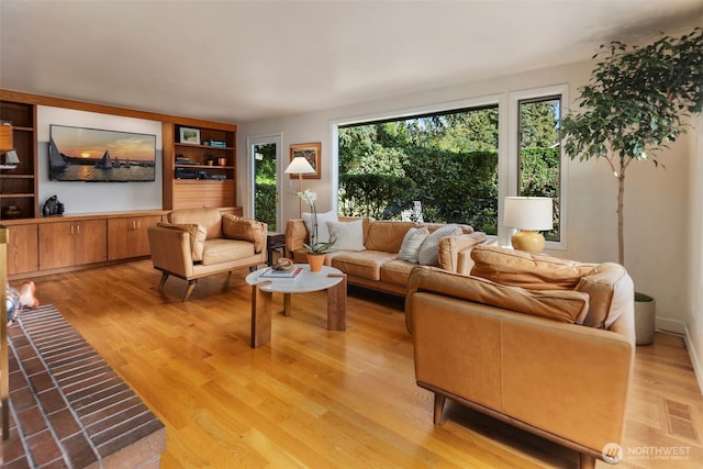 4662 95th Ave NE, Yarrow Point, WA 98004 - living room with built in features and light wood-style floors