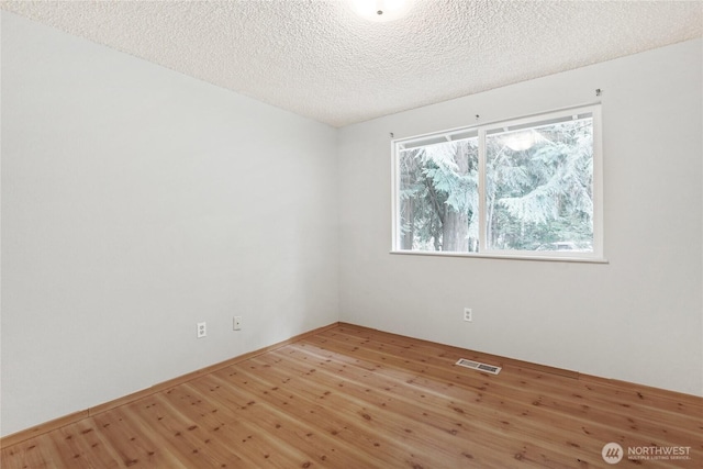 8200 NE View Ridge Ln, Poulsbo, WA 98370 - unfurnished room featuring wood finished floors and a textured ceiling