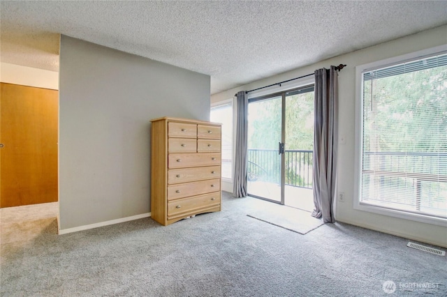 908 185th St SW, Lynnwood, WA 98037 - bedroom with access to exterior, carpet floors, and a textured ceiling