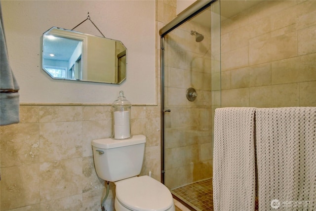 908 185th St SW, Lynnwood, WA 98037 - bathroom featuring a shower stall, tile walls, and wainscoting