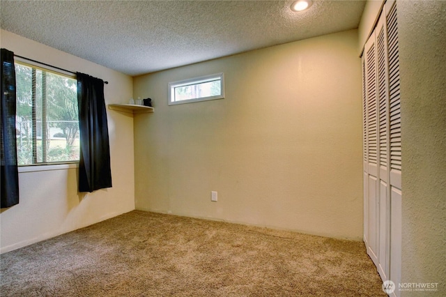 908 185th St SW, Lynnwood, WA 98037 - unfurnished bedroom featuring carpet floors, a closet, and a textured ceiling