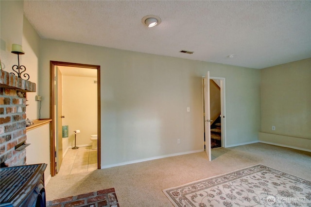 908 185th St SW, Lynnwood, WA 98037 - unfurnished bedroom featuring light colored carpet, a textured ceiling, and connected bathroom