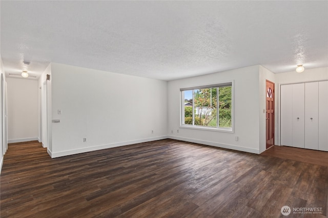 1538 Orchid Ct, Longview, WA 98632 - unfurnished living room featuring dark wood-style flooring and a textured ceiling