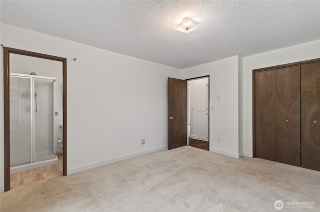1538 Orchid Ct, Longview, WA 98632 - unfurnished bedroom with a textured ceiling, carpet flooring, a closet, and ensuite bathroom