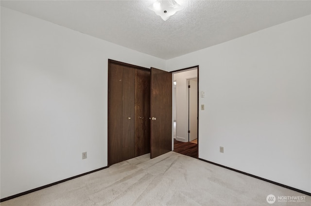 1538 Orchid Ct, Longview, WA 98632 - unfurnished bedroom featuring a textured ceiling, a closet, and light carpet