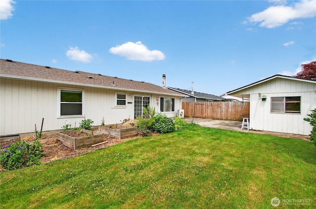 1538 Orchid Ct, Longview, WA 98632 - back of house with a vegetable garden and a patio area
