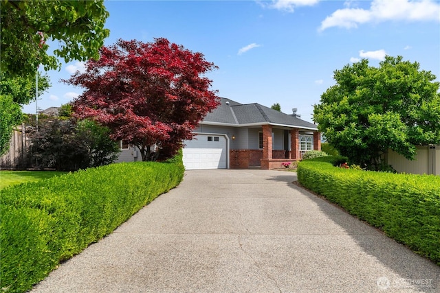 840 Amy Ct, East Wenatchee, WA 98802 - view of front of house featuring brick siding, a garage, and driveway