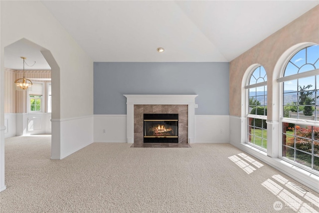 840 Amy Ct, East Wenatchee, WA 98802 - unfurnished living room featuring a chandelier, carpet floors, a fireplace, lofted ceiling, and a wainscoted wall