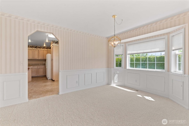 840 Amy Ct, East Wenatchee, WA 98802 - spare room with wallpapered walls, a wainscoted wall, a chandelier, light carpet, and a decorative wall