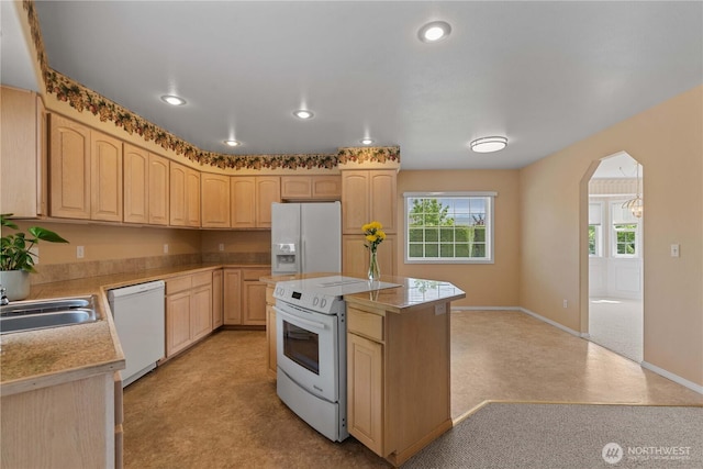 840 Amy Ct, East Wenatchee, WA 98802 - kitchen with white appliances, light brown cabinetry, arched walkways, light countertops, and recessed lighting