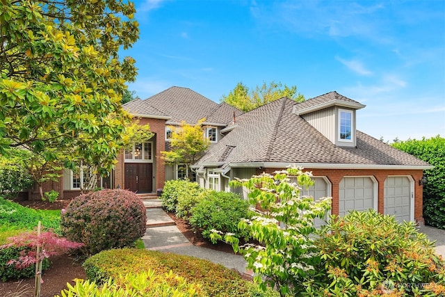 2778 142nd Pl NE, Bellevue, WA 98007 - view of front of house featuring brick siding, an attached garage, driveway, and roof with shingles