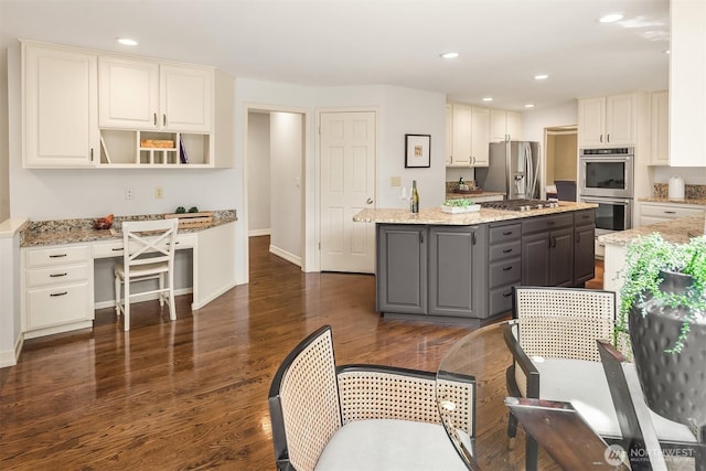 2778 142nd Pl NE, Bellevue, WA 98007 - kitchen featuring stainless steel appliances, gray cabinetry, built in study area, a kitchen island, and dark wood-style flooring