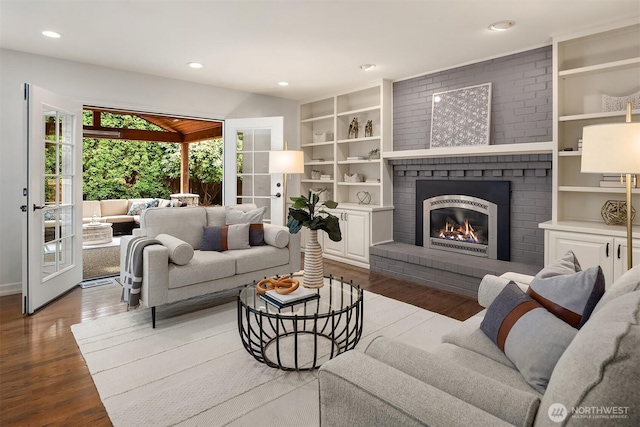 2778 142nd Pl NE, Bellevue, WA 98007 - living area with wood finished floors, a brick fireplace, recessed lighting, french doors, and built in features