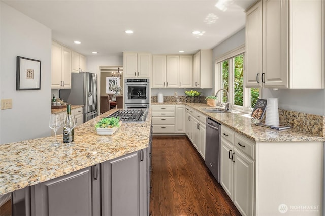 2778 142nd Pl NE, Bellevue, WA 98007 - kitchen featuring appliances with stainless steel finishes, light stone counters, dark wood-style flooring, recessed lighting, and white cabinetry