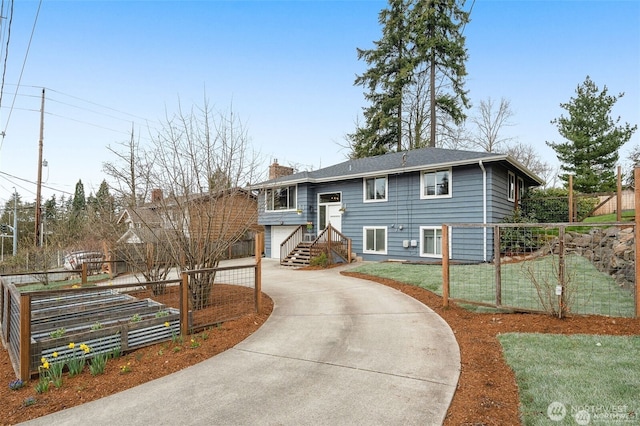 5113 212th St SW, Lynnwood, WA 98036 - raised ranch with driveway, a chimney, a garden, and an attached garage