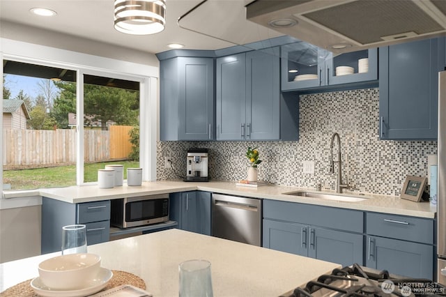 5113 212th St SW, Lynnwood, WA 98036 - kitchen with appliances with stainless steel finishes, tasteful backsplash, glass insert cabinets, exhaust hood, and recessed lighting