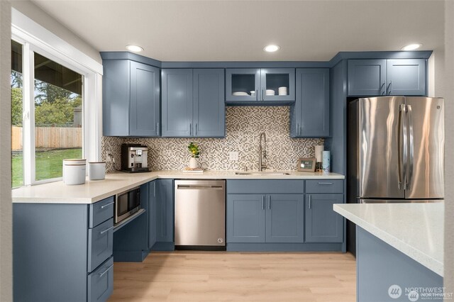 5113 212th St SW, Lynnwood, WA 98036 - kitchen featuring appliances with stainless steel finishes, backsplash, light wood-style flooring, light countertops, and recessed lighting