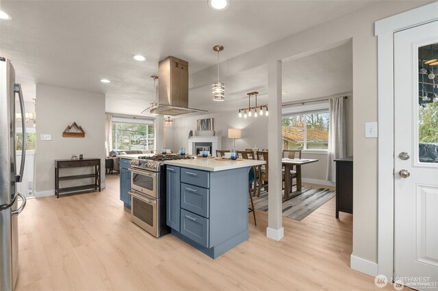 5113 212th St SW, Lynnwood, WA 98036 - kitchen with extractor fan, appliances with stainless steel finishes, recessed lighting, light wood-type flooring, and light countertops