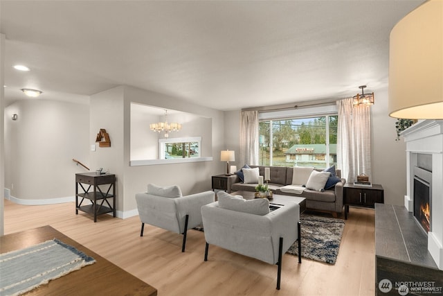 5113 212th St SW, Lynnwood, WA 98036 - living room featuring a chandelier, wood finished floors, and a warm lit fireplace