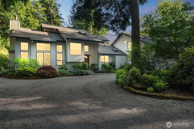 24230 218th Ave SE, Maple Valley, WA 98038 - view of front of house with a chimney, dirt driveway, and a shingled roof