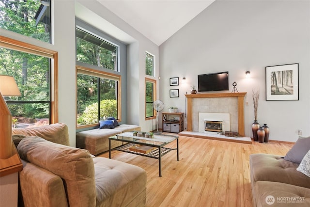 24230 218th Ave SE, Maple Valley, WA 98038 - living area with high vaulted ceiling, wood finished floors, and a fireplace