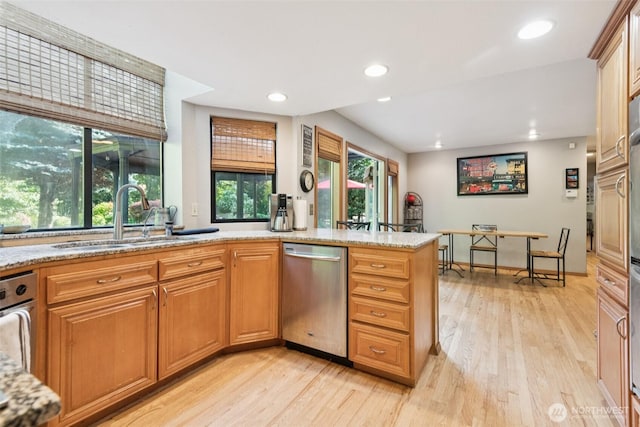 24230 218th Ave SE, Maple Valley, WA 98038 - kitchen with stainless steel dishwasher, light wood-style floors, light stone counters, and recessed lighting