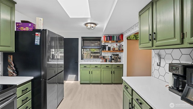 501 143rd St S, Tacoma, WA 98444 - kitchen with green cabinets, light countertops, and light wood-style flooring