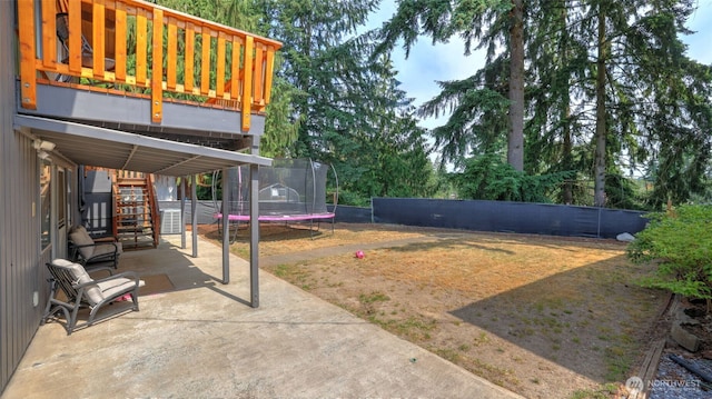 501 143rd St S, Tacoma, WA 98444 - fenced backyard with a trampoline, a patio area, and stairway