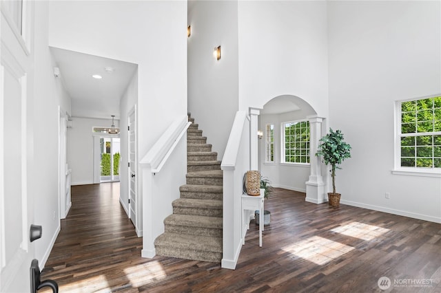 1611 Austin Ave, Snohomish, WA 98290 - entrance foyer with healthy amount of natural light, a towering ceiling, wood finished floors, decorative columns, and stairs