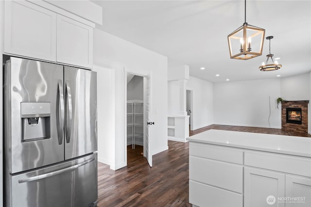 1611 Austin Ave, Snohomish, WA 98290 - kitchen featuring stainless steel fridge, open floor plan, dark wood-style flooring, white cabinets, and light countertops