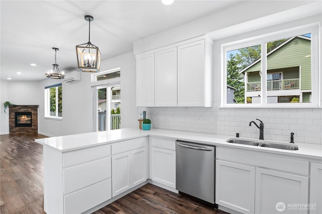 1611 Austin Ave, Snohomish, WA 98290 - kitchen with stainless steel dishwasher, a peninsula, light countertops, decorative backsplash, and white cabinets