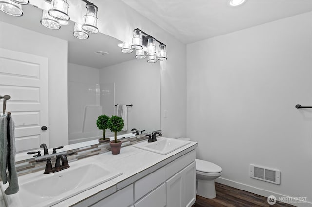 1611 Austin Ave, Snohomish, WA 98290 - full bathroom with double vanity, wood finished floors, and a shower